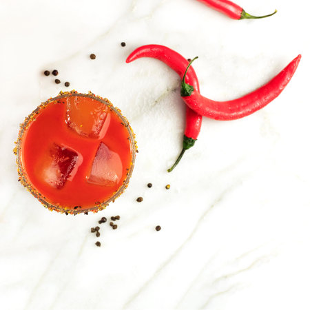 Bloody Mary cocktail, shot from above on white marble