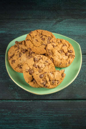 A teal plate of chocolate chips cookies with copyspaceの写真素材