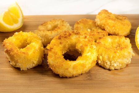 Closeup of fried calamari rings with lemon and copyspaceの写真素材