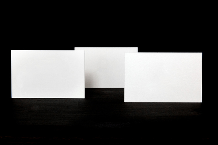 Thick cardboard business cards, blank for copyspace, on blackの写真素材