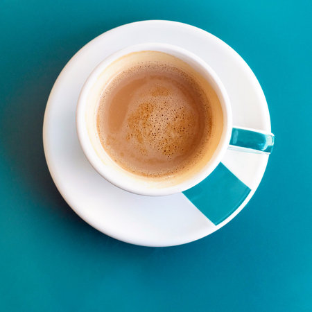 Cup of coffee on turquoise with copyspaceの写真素材