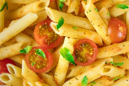 Overhead photo of pasta with tomatoes and basilの写真素材