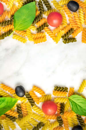 Pasta salad ingredients on white marble with copyspaceの写真素材