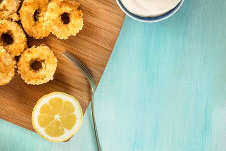 Calamari rings, mayonnaise sauce, lemon, copy spaceの写真素材