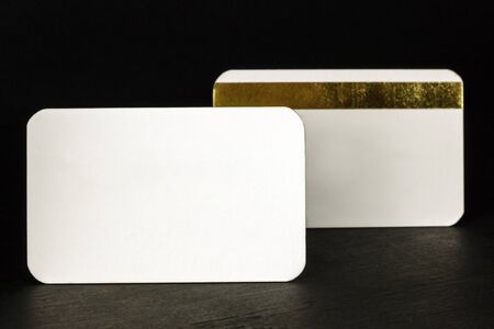 Blank white business cards with rounded corners on blackの写真素材