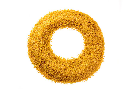 Heart made of couscous, shot from above on white
