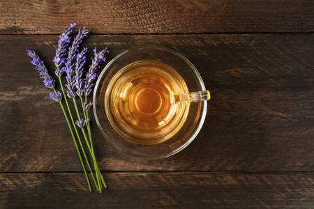 Cup of tea with lavender flowers bouquet and copyspaceの写真素材
