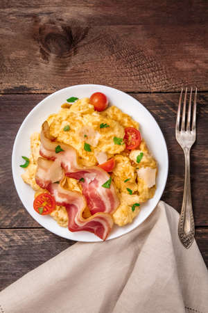 Scrambled eggs with cheese, bacon, and copy spaceの写真素材