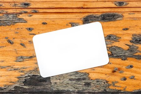 Blank white business card with copyspace on rustic backgroundの写真素材