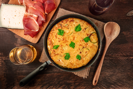 Spanish tortilla in tortillera, with wine, jamon, and cheeseの写真素材