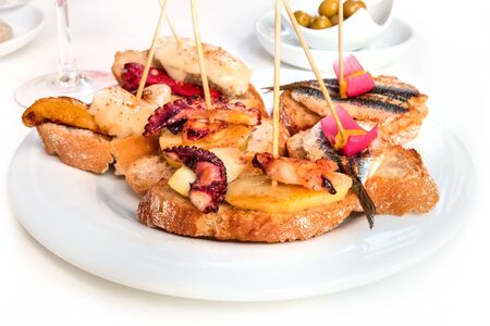 Spanish seafood tapas on a white backgroundの写真素材