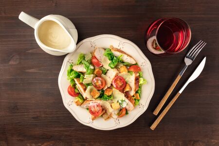 Chicken Caesar salad on rustic background with copyspaceの写真素材