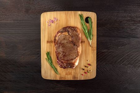 Cooked meat on rustic textures with seasoning and copyspaceの写真素材