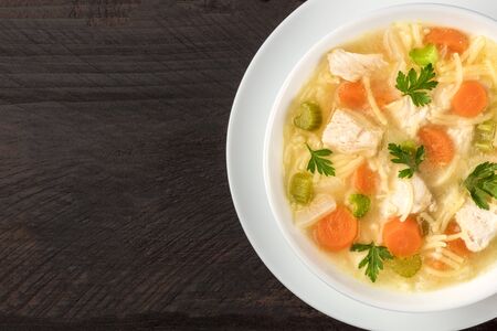 Chicken soup with noodles, overhead closeup photo with copyspaceの写真素材