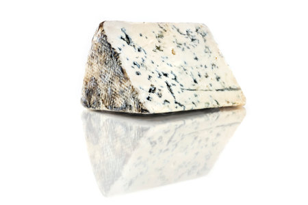 Slice of blue cheese with reflection on whiteの写真素材