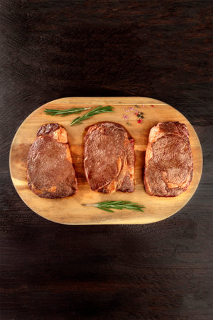 Cooked meat on rustic textures with seasoning and copyspaceの写真素材