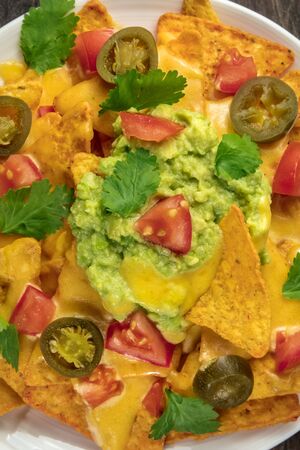 Closeup of nachos with cheese and hot peppers, Mexican snackの写真素材