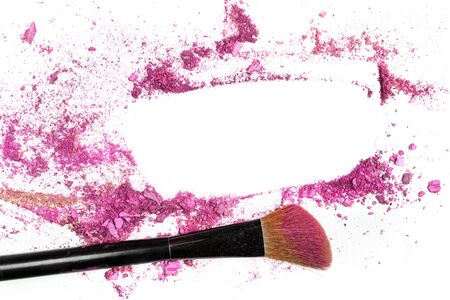 Pink blush and eye shadow forming frame, with makeup brushの写真素材