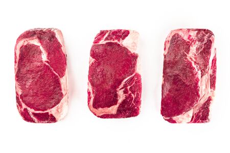 Three slices of raw meat on white with copy spaceの写真素材