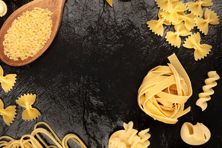 Overhead photo of different types of pasta on blackの写真素材