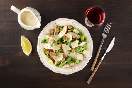 Chicken Caesar salad on rustic background with copyspaceの写真素材