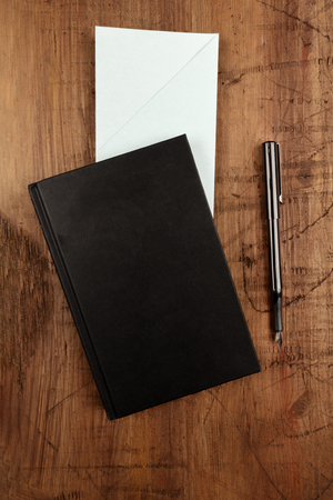 Black book, blue envelope, ink pen, and place for textの写真素材