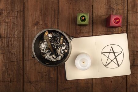 Overhead photo of cauldron, grimoire, and candlesの写真素材