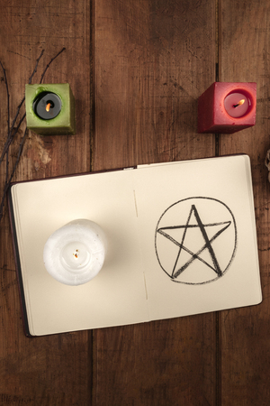 Overhead photo of open grimoire and candles, Wicca symbolsの写真素材