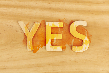 Yes, letters forming word on a wooden background with copy spaceの写真素材