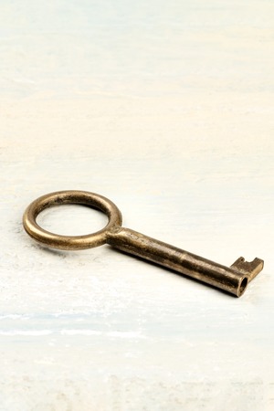 A photo of a vintage key on a light background with copyspaceの写真素材