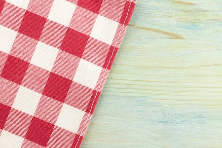 An overhead photo of a gingham cloth on a teal background, an abstract restaurant background with a place for textの写真素材
