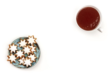 Christmas Zimsterne, cinnamon star cookies, shot from the top on a white background with hot chocolate and copy spaceの写真素材