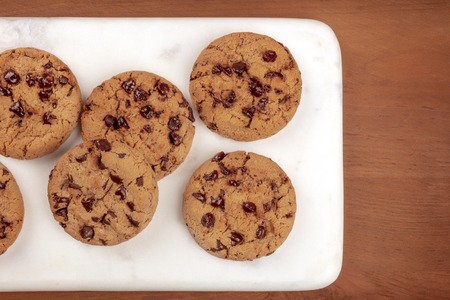 Chocolate chip cookies, shot from the top on a dark rustic wooden background with copy spaceの写真素材
