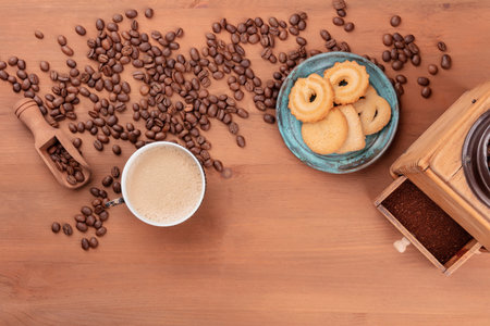 Coffee in a vintage cup, shot from the top with coffee beans, a scoop, and Danish butter cookies, with copy spaceの写真素材