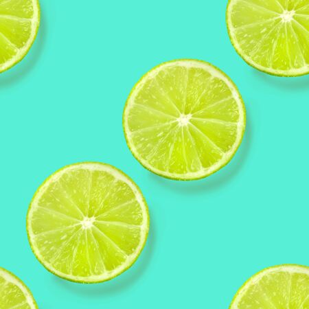 A seamless limes pattern on a vibrant teal blue background, a fruity citrus repeat printの写真素材