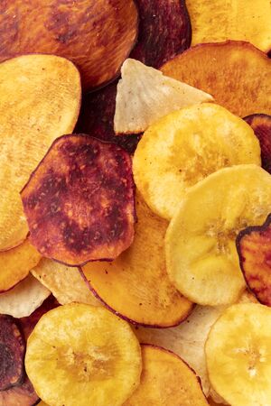 A close-up of dry fruit and vegetable chips, healthy vegan snack, a tasty mixの写真素材