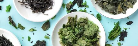 A panorama of dried seaweed, sea vegetables, shot from above on a blue backgroundの写真素材