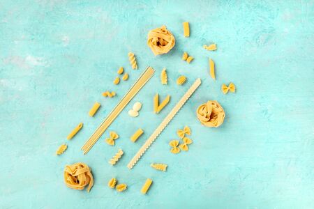Italian pasta variety, flat lay banner, shot from the top on a teal blue background with a place for textの写真素材
