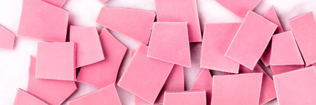 A panorama of ruby chocolate, overhead shot on a white marble background