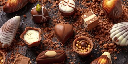 Belgian chocolate assortment panorama, various bonbons on a dark backgroundの写真素材