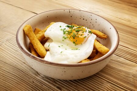 Huevos rotos, typical Spanish dish with potatoes and eggsの写真素材