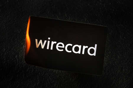 Madrid, Spain - June 27, 2020: Wirecard prepaid card burning on fire following the company bankruptcy and the freezing of cardholders moneyのeditorial素材