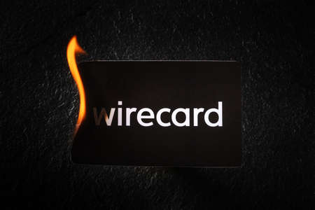 Madrid, Spain - June 27, 2020: Wirecard prepaid card burning on fire following the company bankruptcy and the freezing of cardholders moneyのeditorial素材