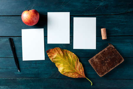 Autumn stationery mockup, three vertical A5 greeting cards or invitations, overhead flat lay shotの写真素材