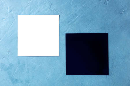 A mockup for two square cards, white and black, with a place for textの写真素材