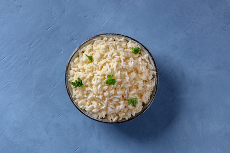 White rice, boiled, served with parsley, shot from the topの写真素材