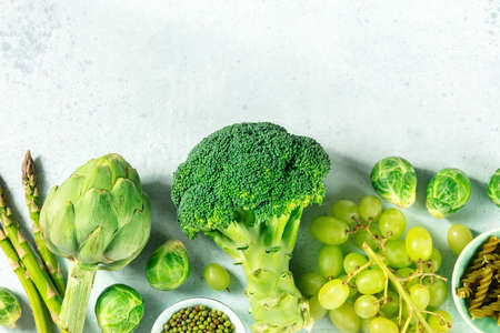 Healthy organic green vegan food banner with a place for text, overhead flat lay shot. Broccoli, artichoke, grapes, asparagus etcの写真素材
