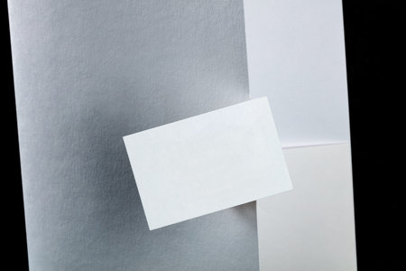 A business card in front of a folder, a mockup for a corporate style design presentation