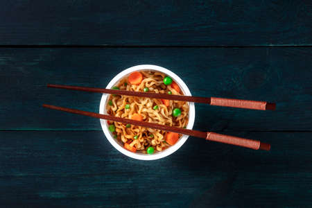 Ramen cup. Instant noodles with chopsticks, shot from the topの写真素材