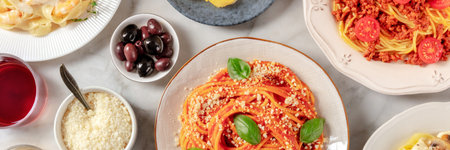 Italian food panorama. Spaghetti, olives, and Parmesan cheese, shot from the topの写真素材